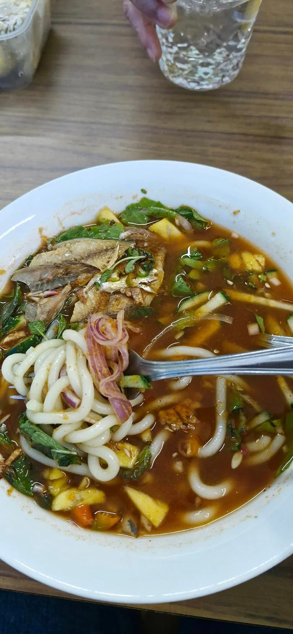 Asam laksa with thick rice noodles, mackerel flakes, mint and pineapple
