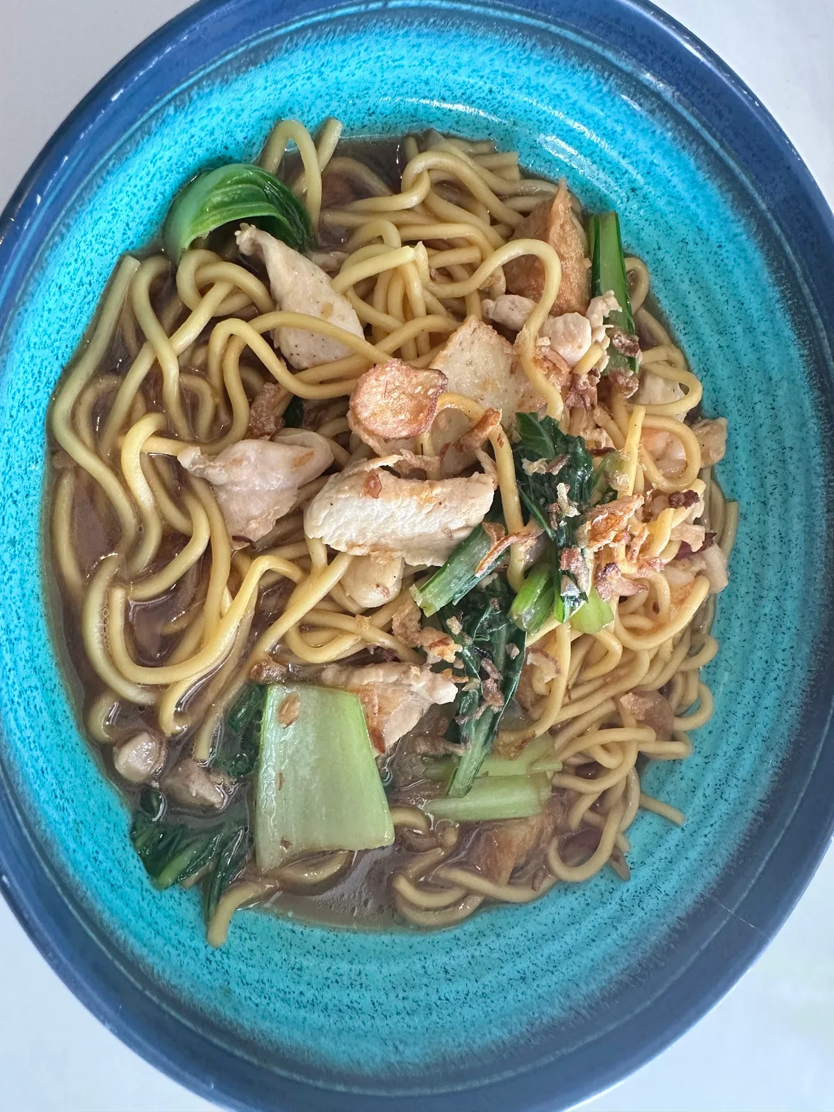 Hainanese fried noodles with chicken and greens