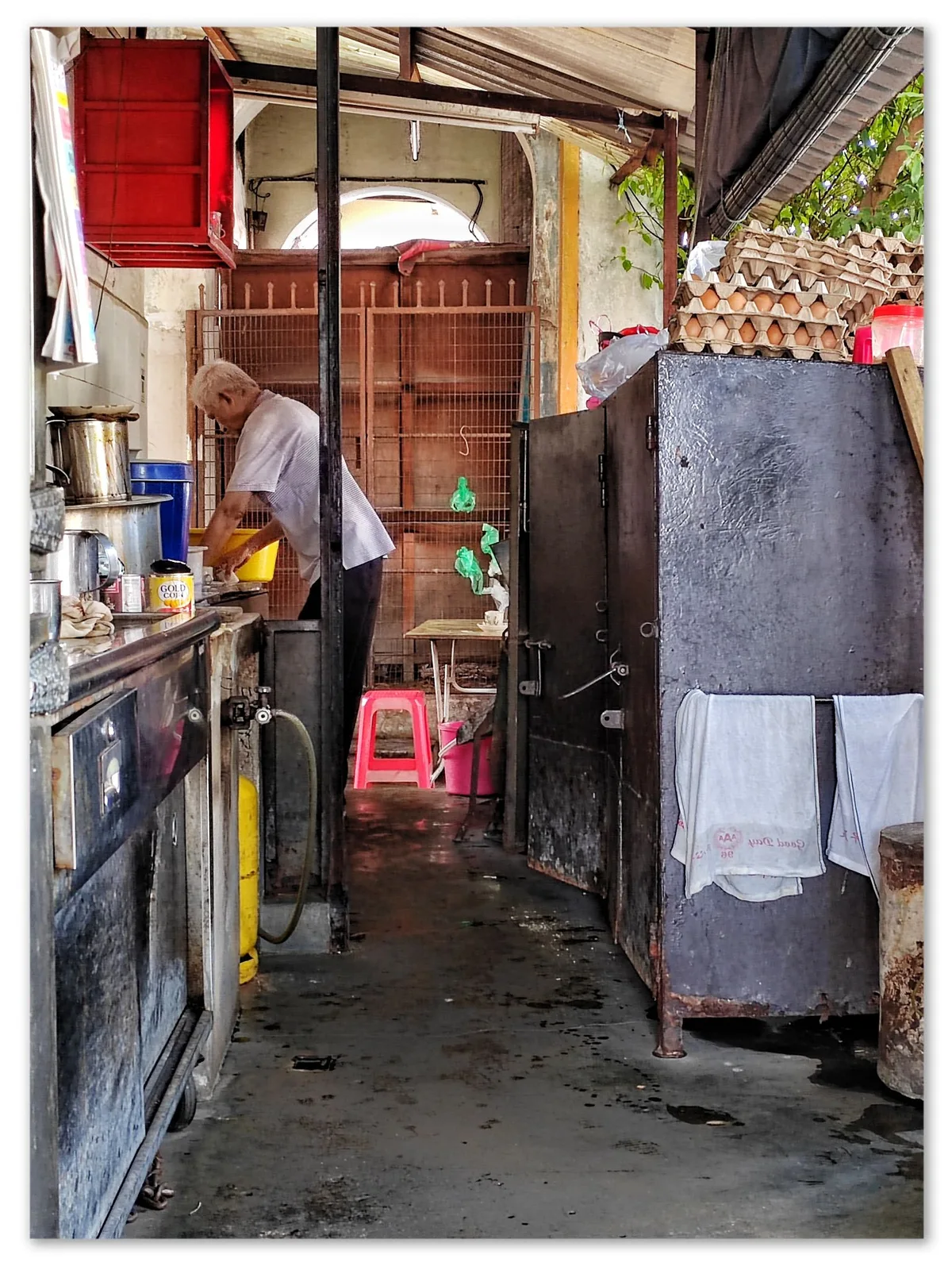 Uncle brewing kopi over charcoal
