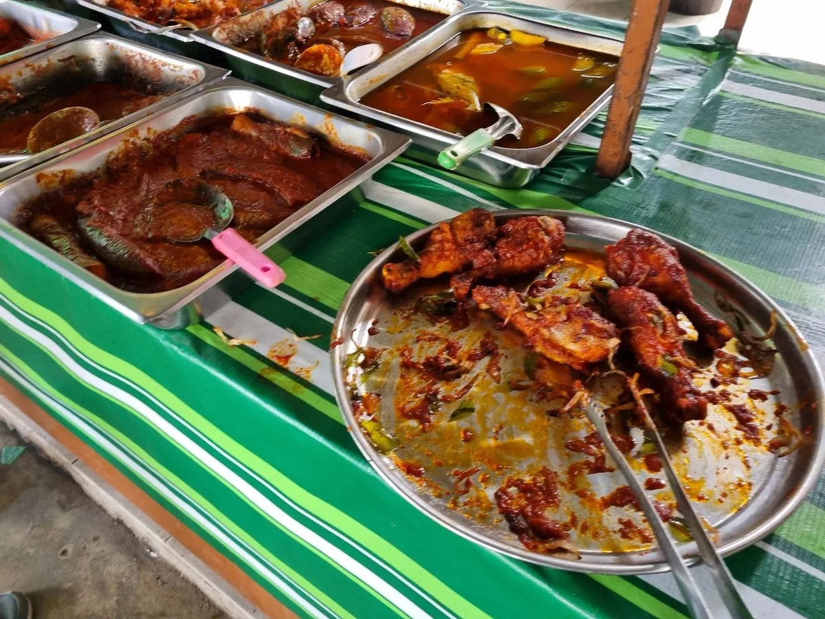 Lauk trays at the buffet line