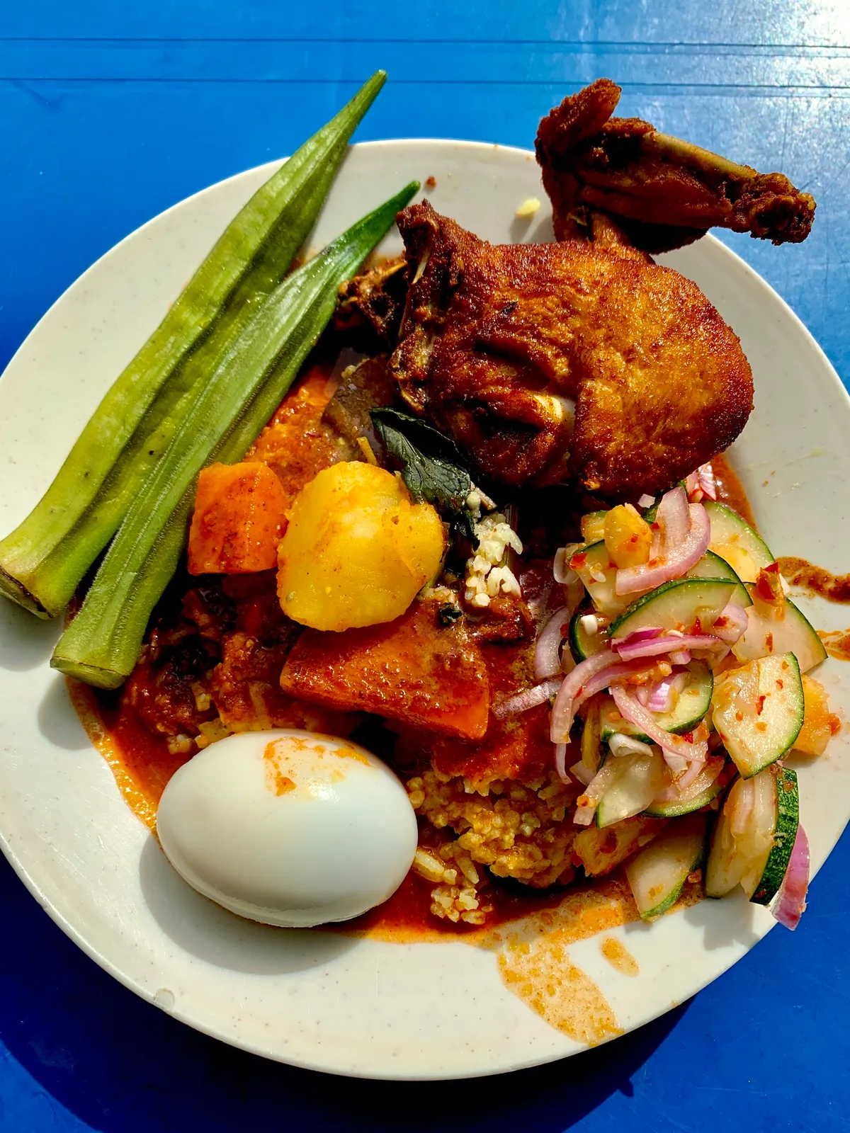 Rice with fried chicken, egg, okra and acar
