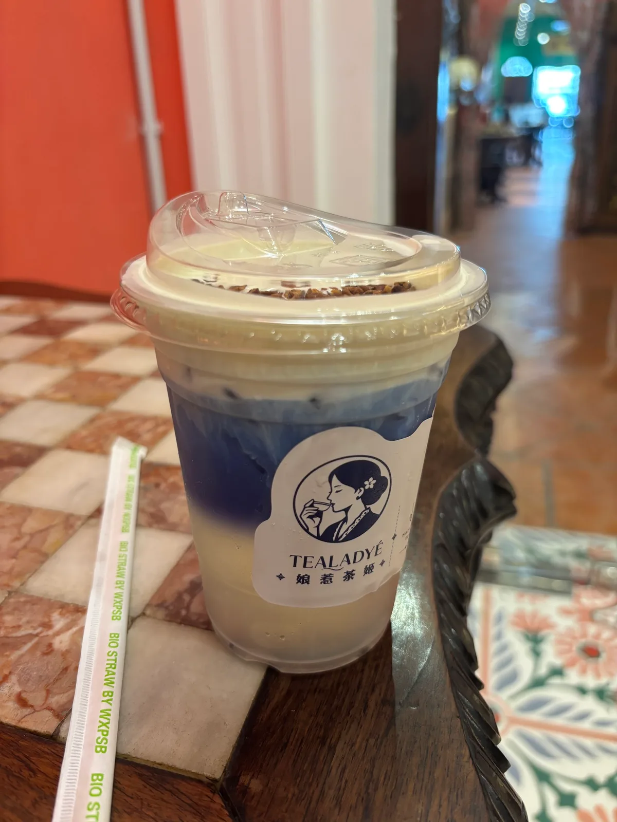 Blue pea drink with cream top on peranakan tiles