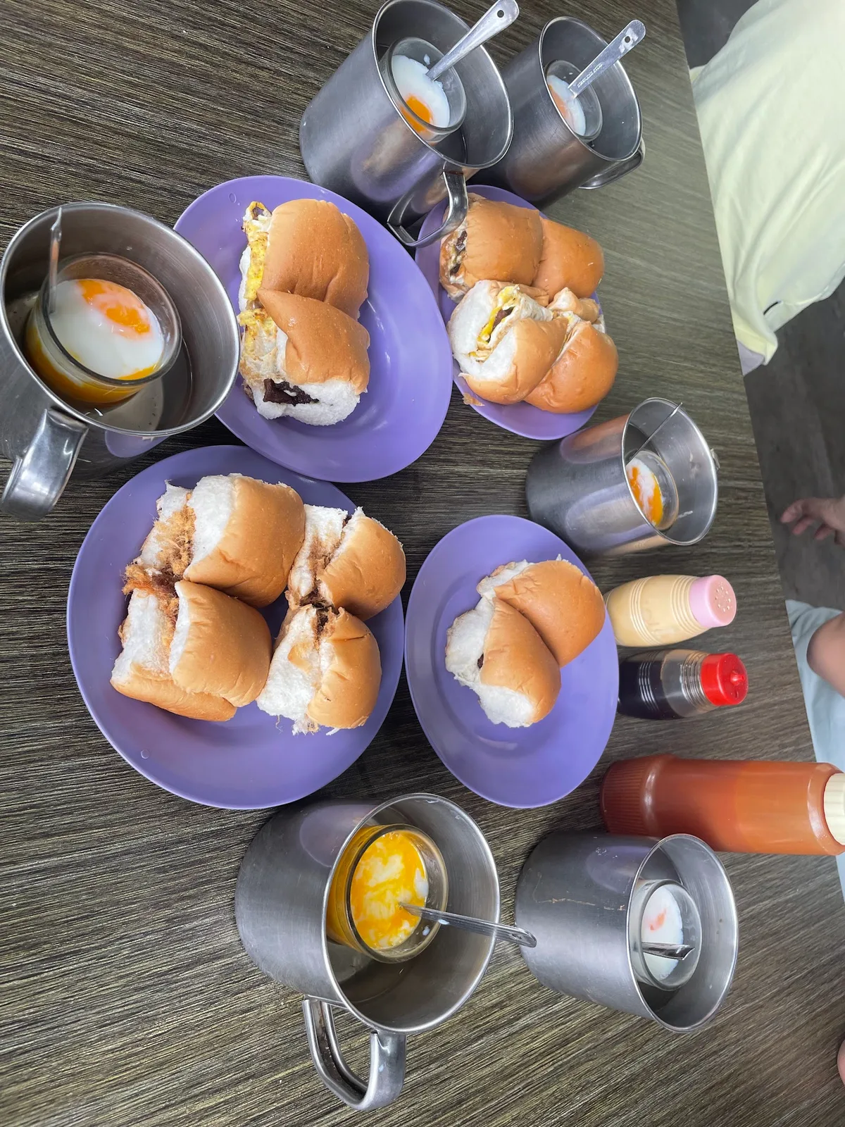 Breakfast spread of buns and half-boiled eggs