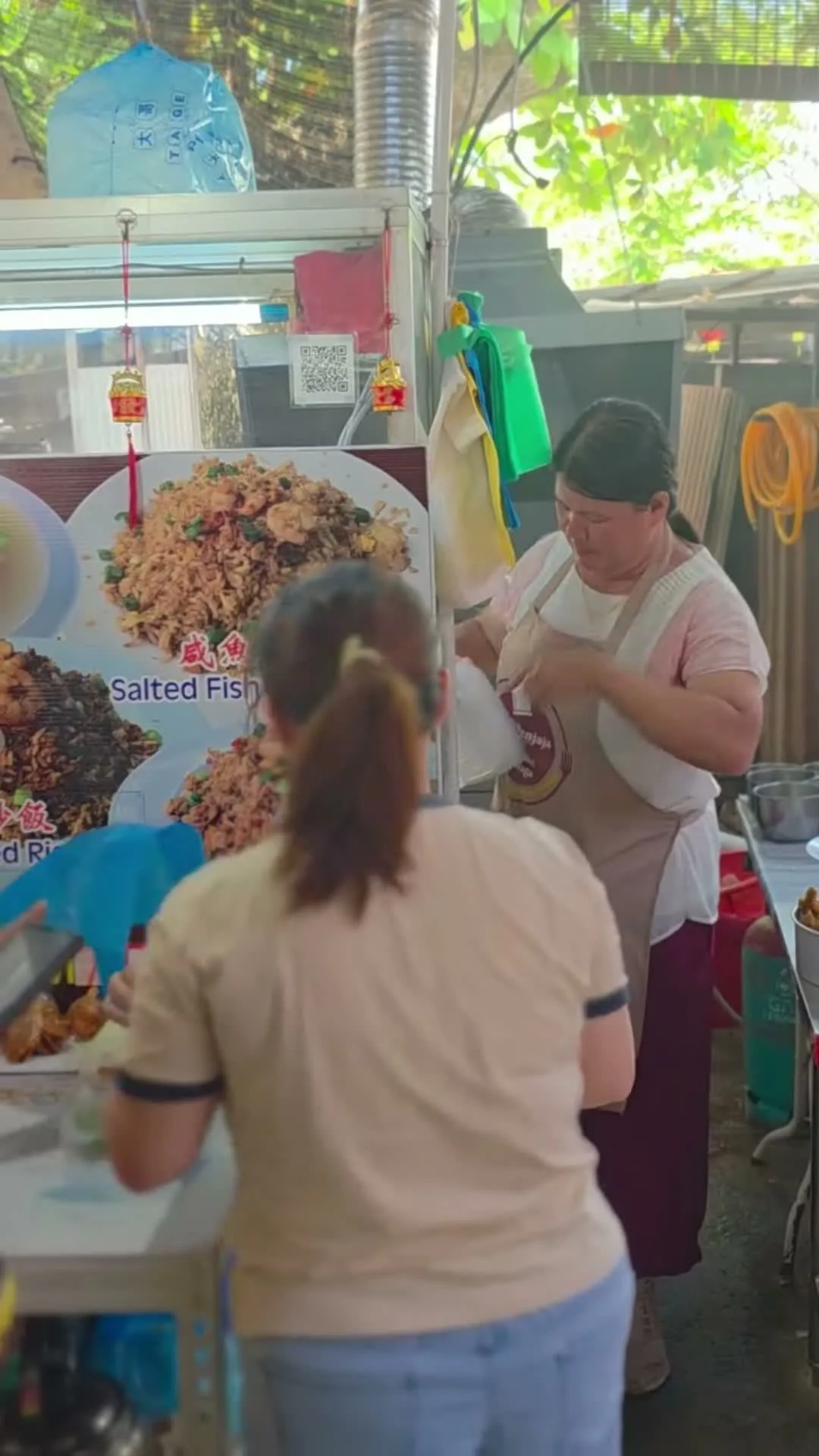 The char hor fun stall at Under The Tree, its menu poster showing the fried rice and salted fish fried rice plates