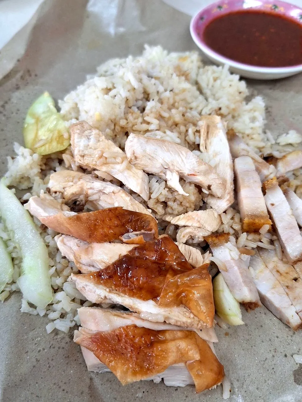 Chicken rice with white chicken, soy chicken and crisp roast pork, chilli sauce on the side