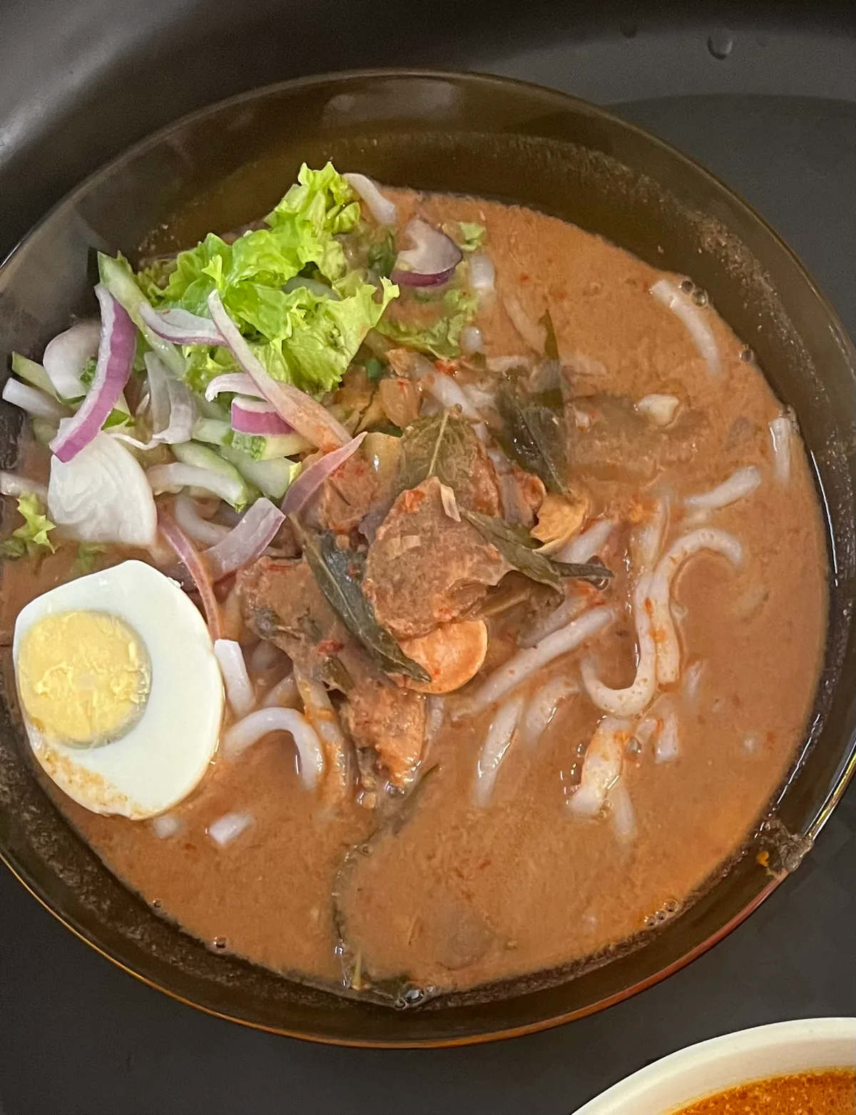 Laksa with egg and red onion