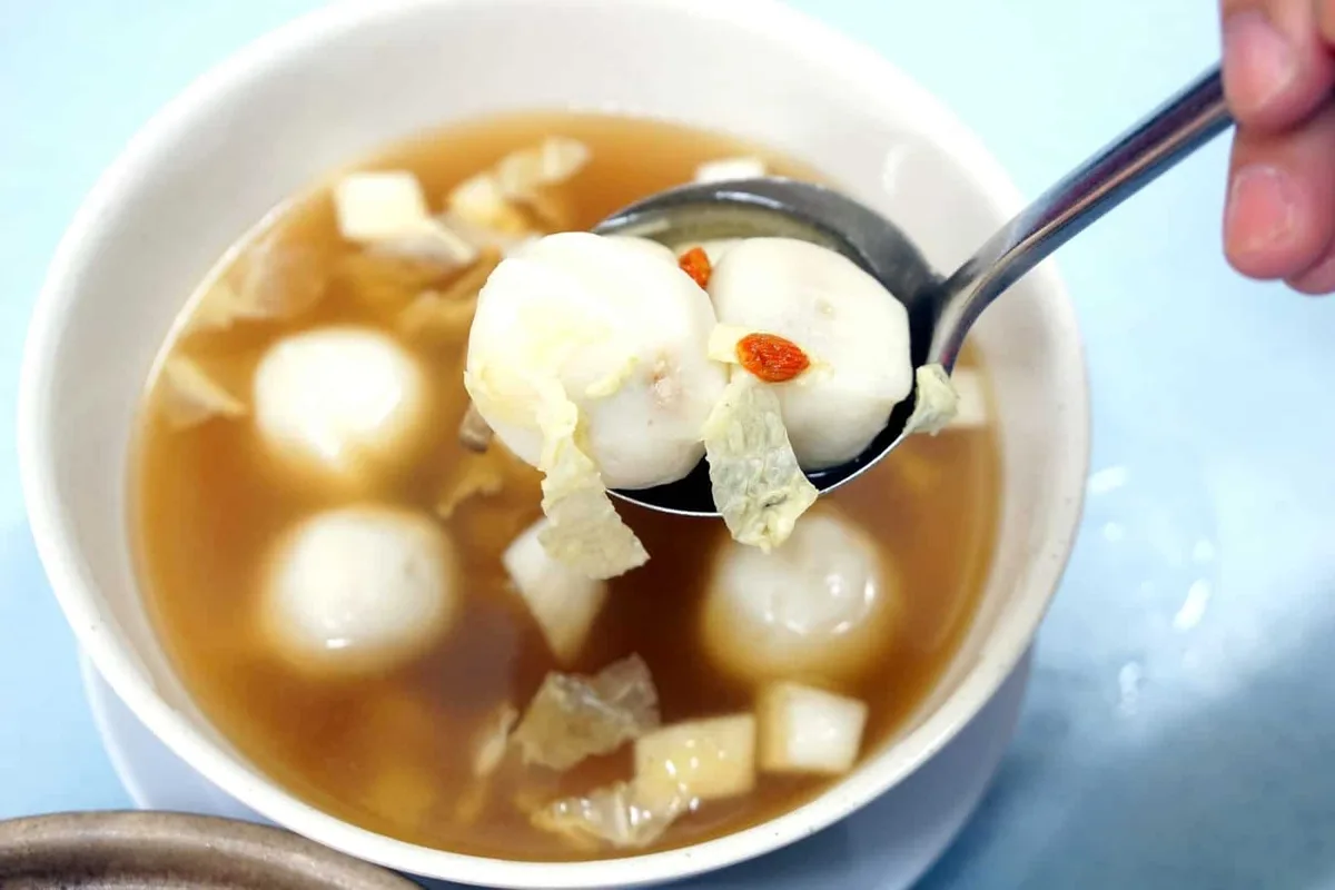 Bowl of fish ball soup with beancurd skin, yam cubes and goji berries