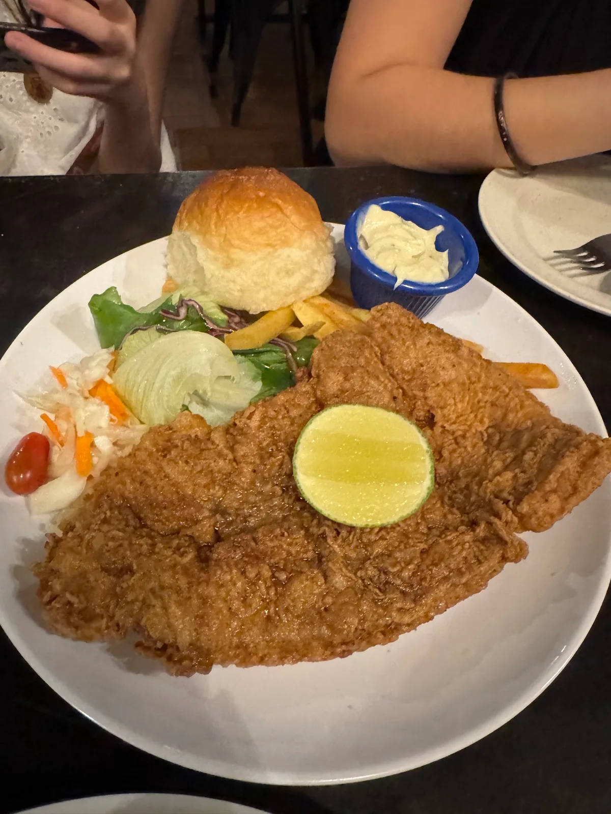 Breaded fish fillet with fries and salad