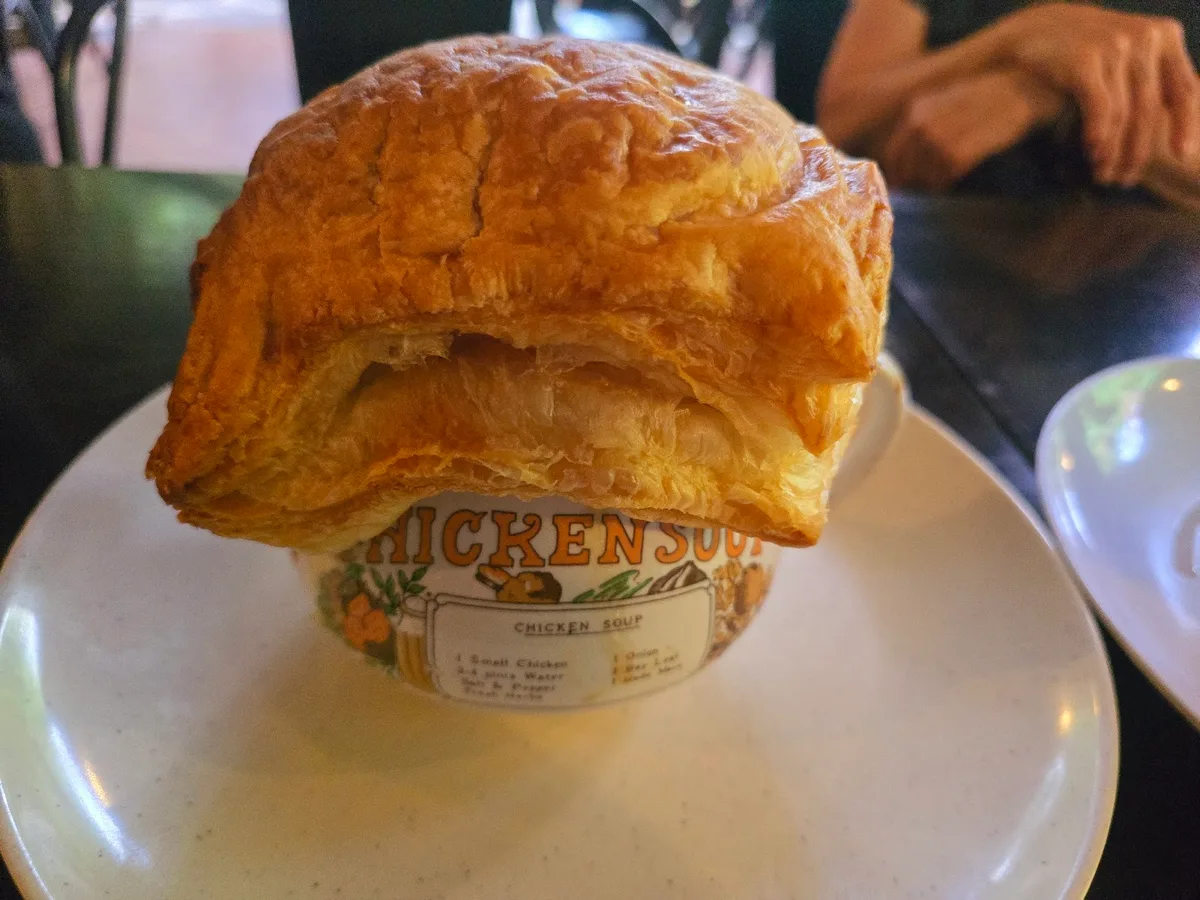Chicken soup under a puff pastry lid